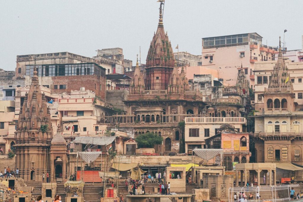 View of the iconic ghats and architecture in Varanasi, Uttar Pradesh, capturing the vibrant urban landscape on a bright day.